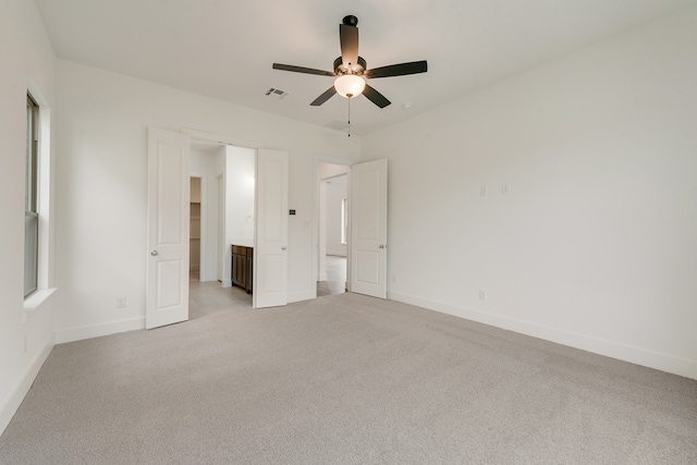 unfurnished bedroom featuring light carpet, ceiling fan, visible vents, and baseboards