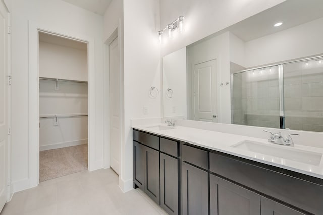1517 Kinglet Pl, Celina, TX 75009 - full bath with a stall shower, double vanity, a walk in closet, and baseboards