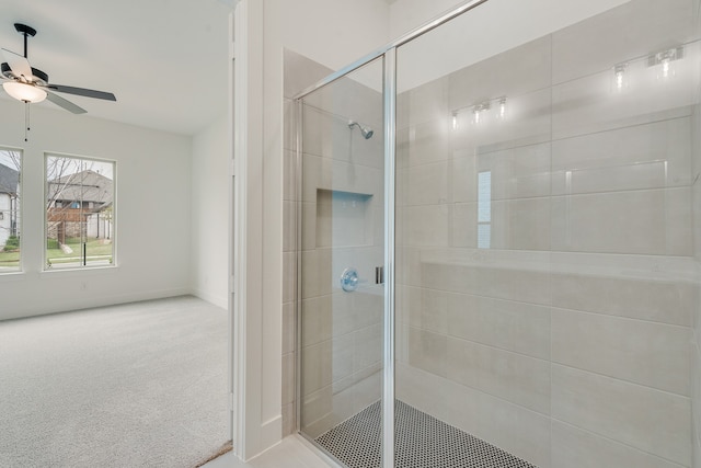 bathroom featuring a ceiling fan and a tile shower