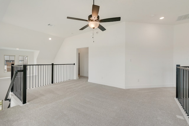 spare room with light carpet, visible vents, vaulted ceiling, and recessed lighting