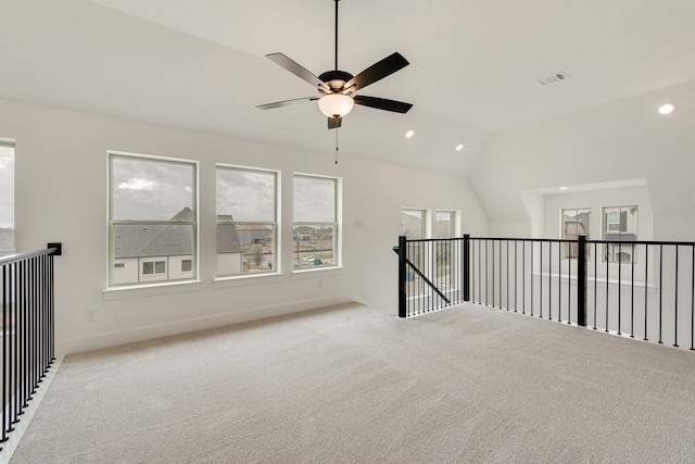 unfurnished room with vaulted ceiling, light carpet, visible vents, and recessed lighting