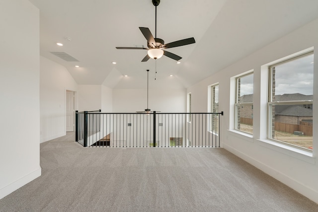 spare room with baseboards, visible vents, light colored carpet, vaulted ceiling, and recessed lighting