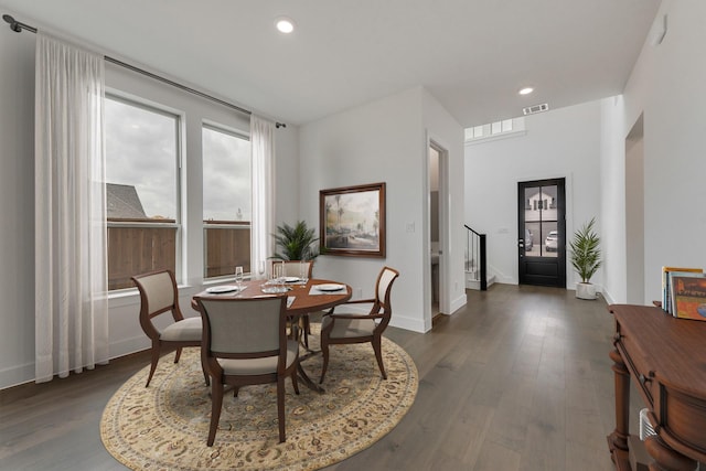 dining space featuring recessed lighting, visible vents, baseboards, stairway, and dark wood finished floors