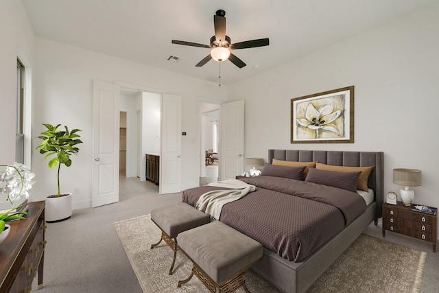 bedroom featuring baseboards, visible vents, a ceiling fan, and light colored carpet