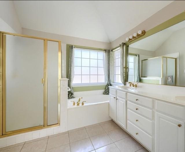 full bath featuring a garden tub, lofted ceiling, a sink, a shower stall, and tile patterned floors