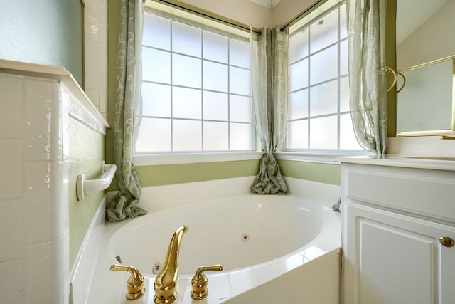 bathroom with a whirlpool tub and a sink