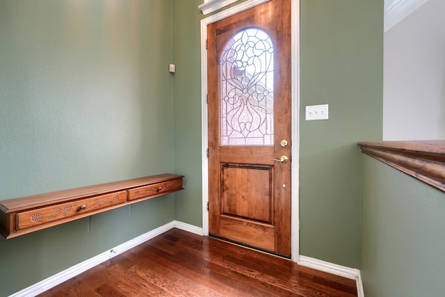 foyer entrance with dark wood finished floors and baseboards