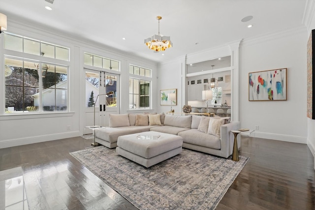 living room featuring dark wood finished floors, recessed lighting, ornamental molding, a chandelier, and baseboards