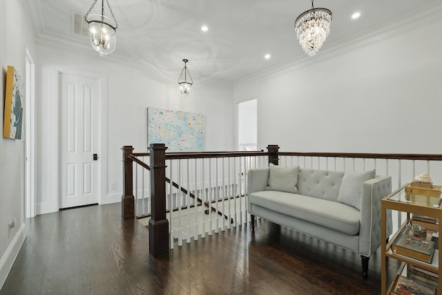 hallway featuring a chandelier, recessed lighting, an upstairs landing, dark wood-style floors, and crown molding