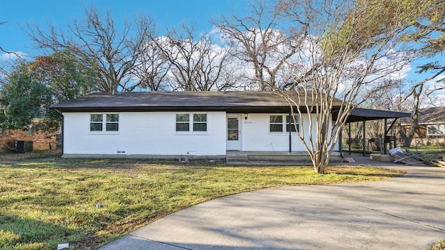 ranch-style home with central air condition unit, brick siding, concrete driveway, a carport, and a front lawn