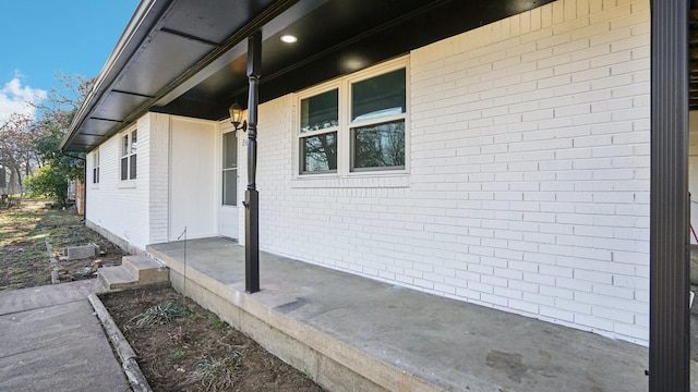 view of side of home with brick siding