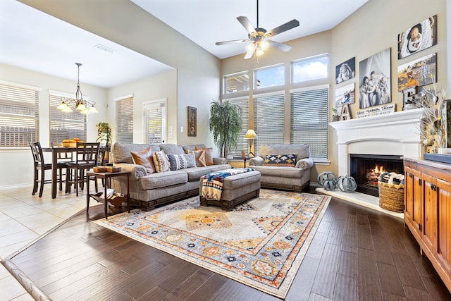 living room with a wealth of natural light, dark wood-type flooring, and visible vents