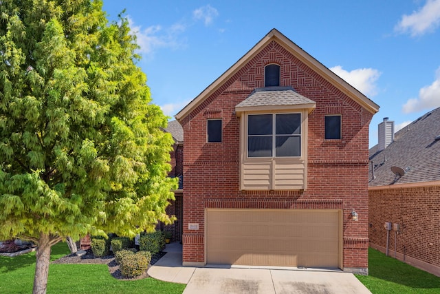 view of front facade featuring driveway, brick siding, and an attached garage