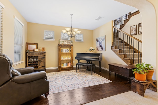 sitting room with hardwood / wood-style floors, stairway, visible vents, and baseboards