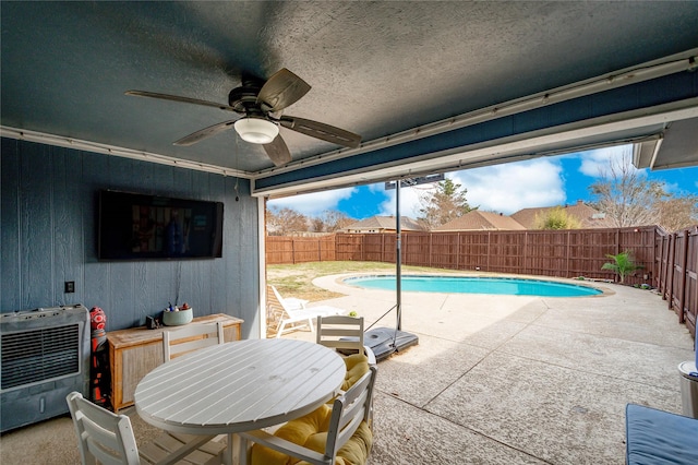 view of swimming pool featuring a patio area, a fenced backyard, a fenced in pool, and a ceiling fan