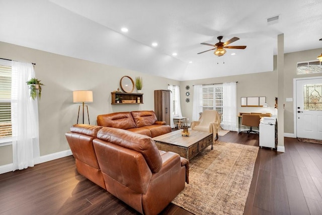 living area with baseboards, vaulted ceiling, visible vents, and dark wood finished floors