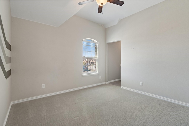 empty room with light carpet, a ceiling fan, and baseboards