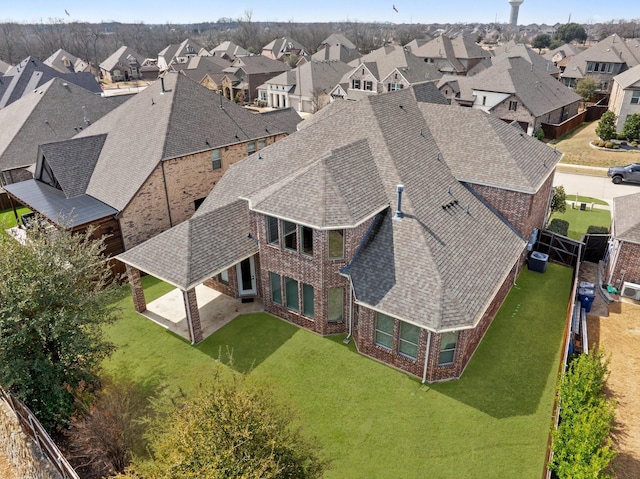 birds eye view of property with a residential view