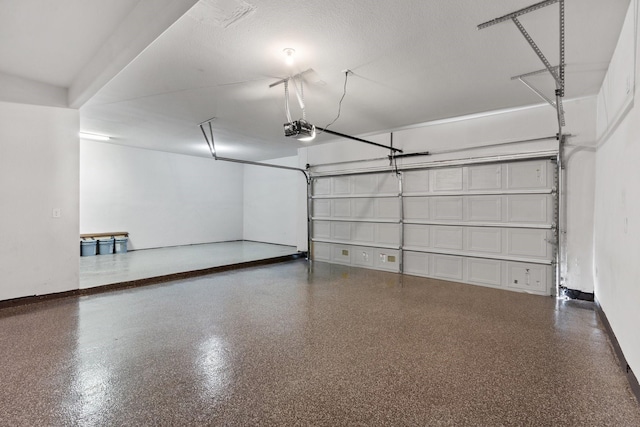 garage featuring baseboards and a garage door opener