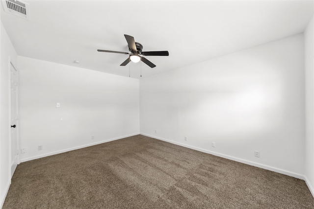 unfurnished room featuring dark colored carpet, a ceiling fan, visible vents, and baseboards