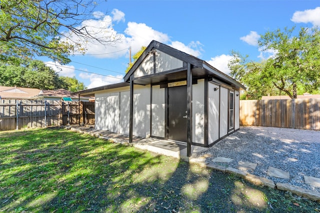 view of outbuilding featuring an outdoor structure and a fenced backyard