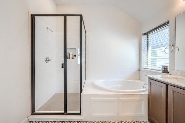 bathroom with lofted ceiling, a garden tub, a shower stall, and vanity