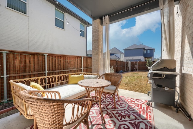view of patio / terrace with grilling area and a fenced backyard