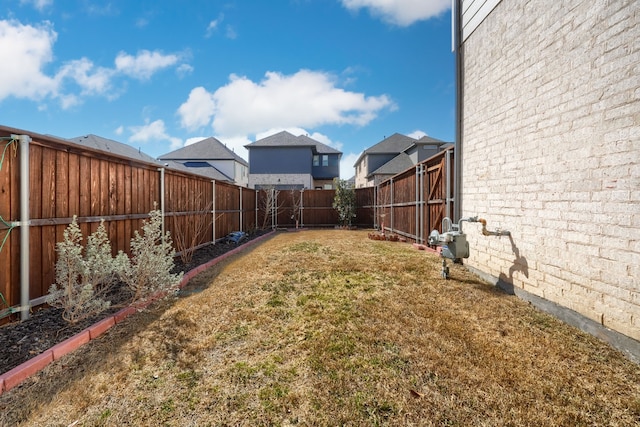 view of yard with a fenced backyard