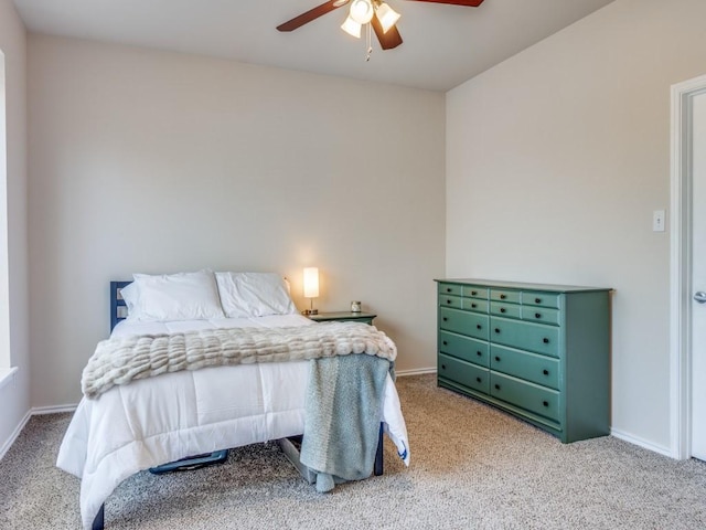 bedroom featuring light carpet, ceiling fan, and baseboards