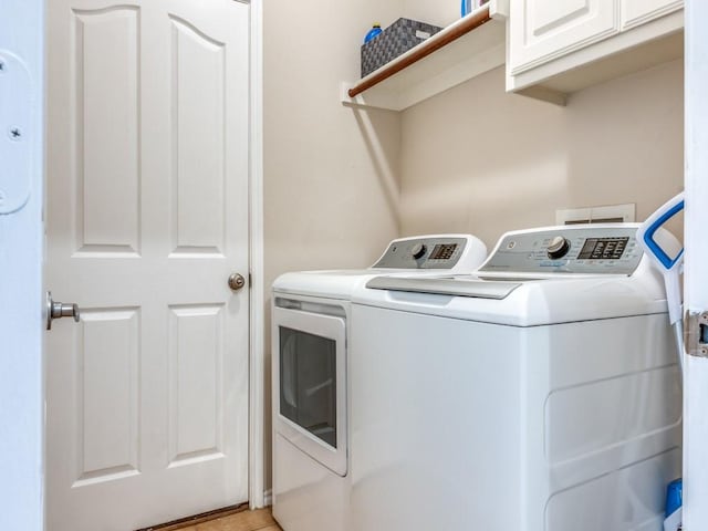 laundry room featuring cabinet space and washing machine and clothes dryer