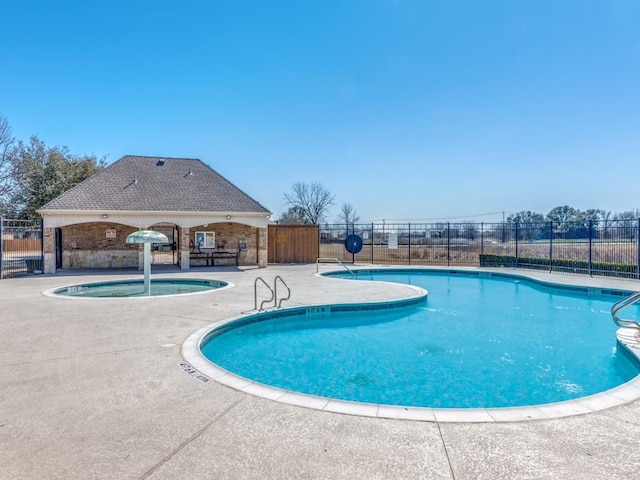 pool featuring fence and a patio