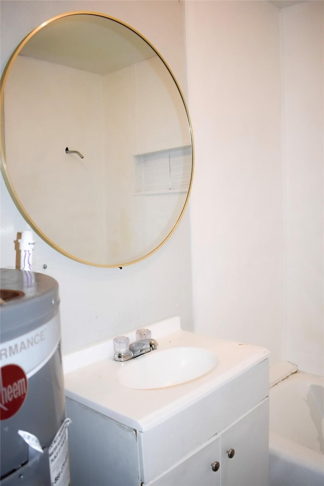 full bath featuring electric water heater, vanity, and a bath