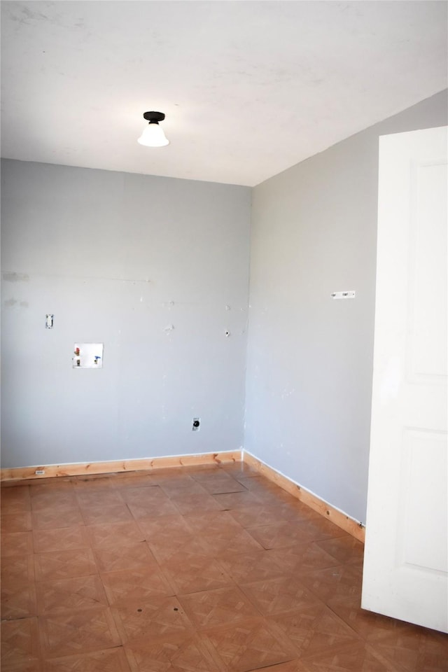 washroom featuring laundry area and baseboards