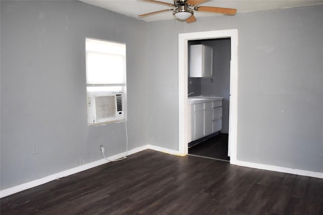 empty room with a ceiling fan, cooling unit, baseboards, and dark wood-type flooring