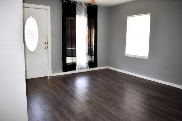 entryway featuring baseboards and dark wood finished floors