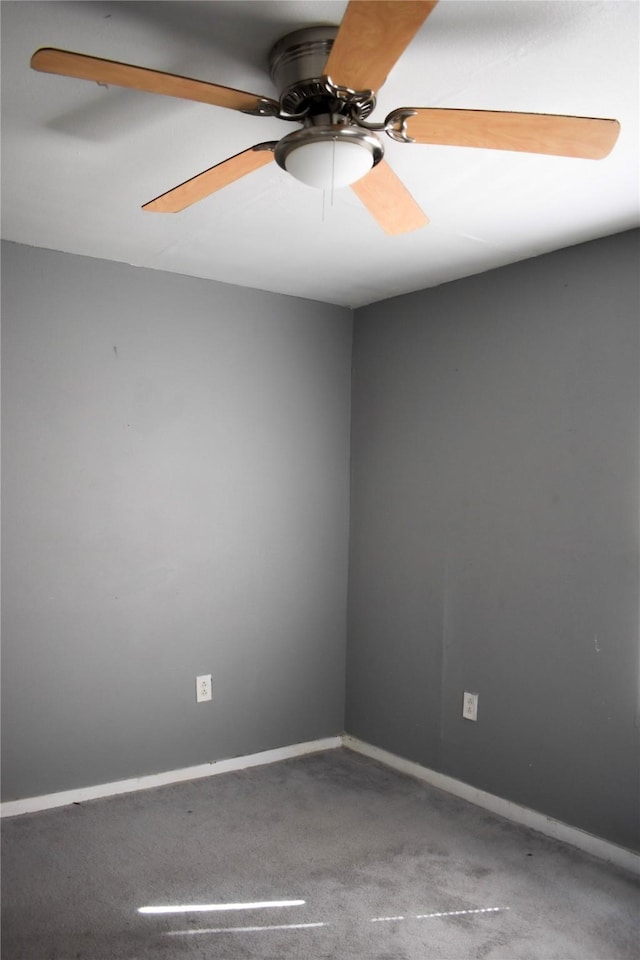 empty room with a ceiling fan and baseboards