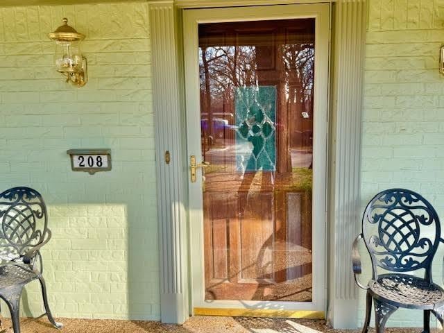 property entrance featuring brick siding