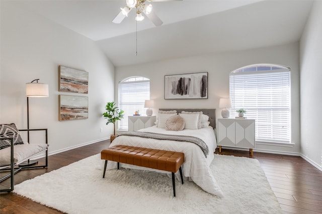 bedroom with vaulted ceiling, ceiling fan, dark wood-style flooring, and baseboards