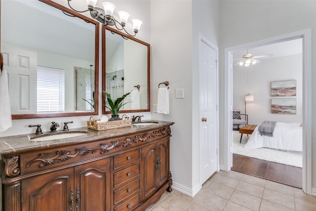 ensuite bathroom featuring tile patterned flooring, a closet, a sink, and ensuite bathroom