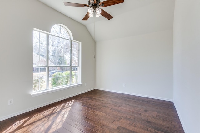 unfurnished room with dark wood finished floors, plenty of natural light, lofted ceiling, and baseboards