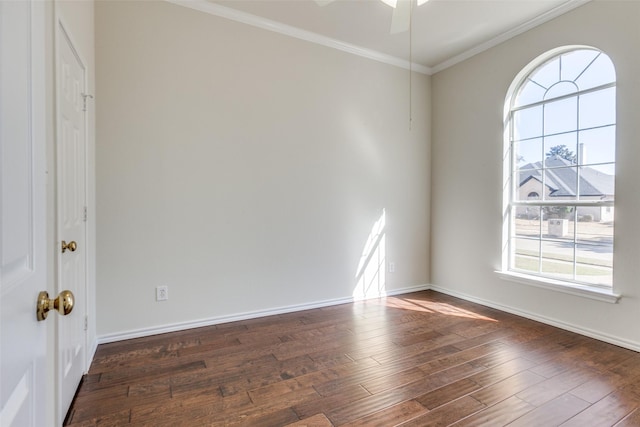 spare room with baseboards, ornamental molding, ceiling fan, and dark wood-style flooring