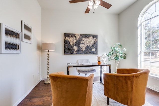 office featuring dark wood-type flooring, baseboards, and a ceiling fan