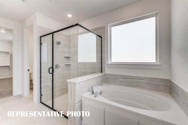 full bathroom featuring toilet, a stall shower, a bath, and recessed lighting