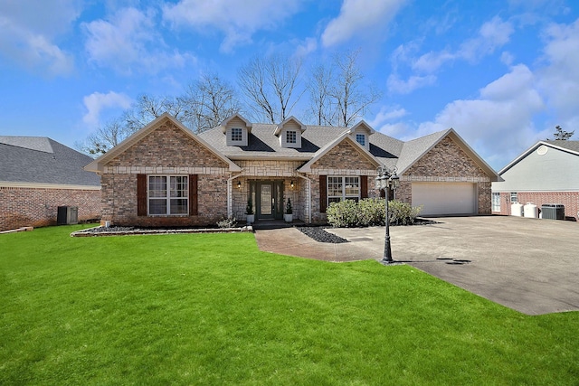 view of front of home with driveway, a garage, a front lawn, and brick siding