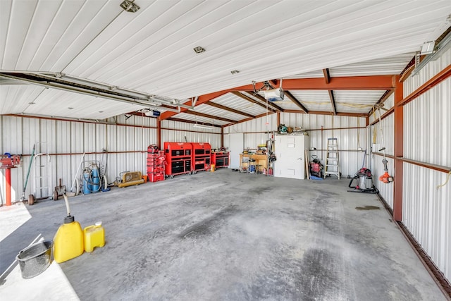 garage featuring metal wall and a garage door opener