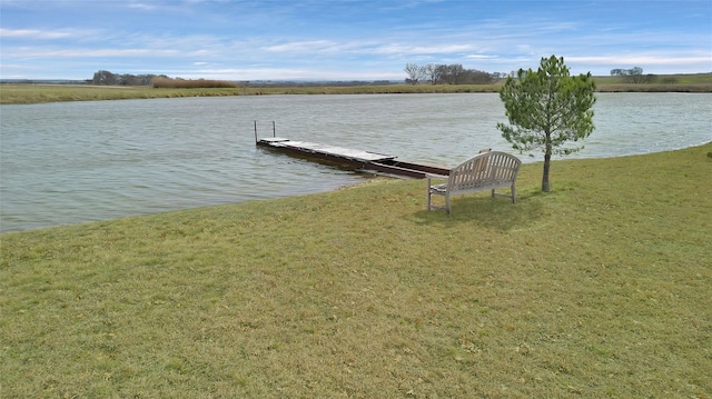 dock area featuring a water view and a lawn