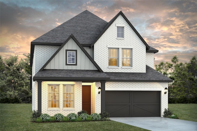 view of front of home with board and batten siding, concrete driveway, brick siding, and a lawn