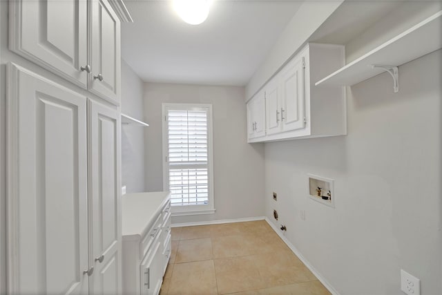 laundry room featuring hookup for a washing machine, cabinet space, light tile patterned flooring, electric dryer hookup, and baseboards