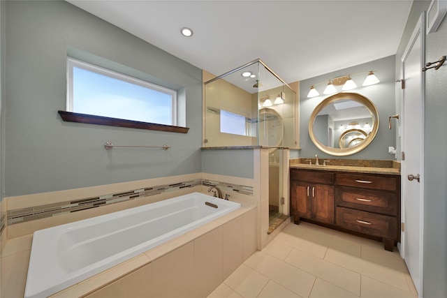 bathroom featuring tiled shower, tile patterned flooring, a garden tub, and vanity