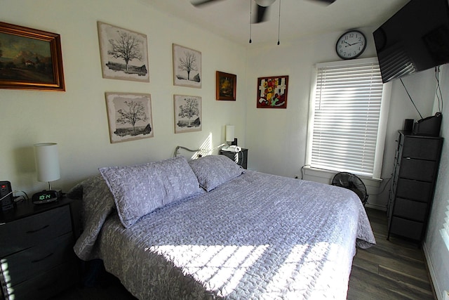 bedroom featuring a ceiling fan and dark wood-type flooring